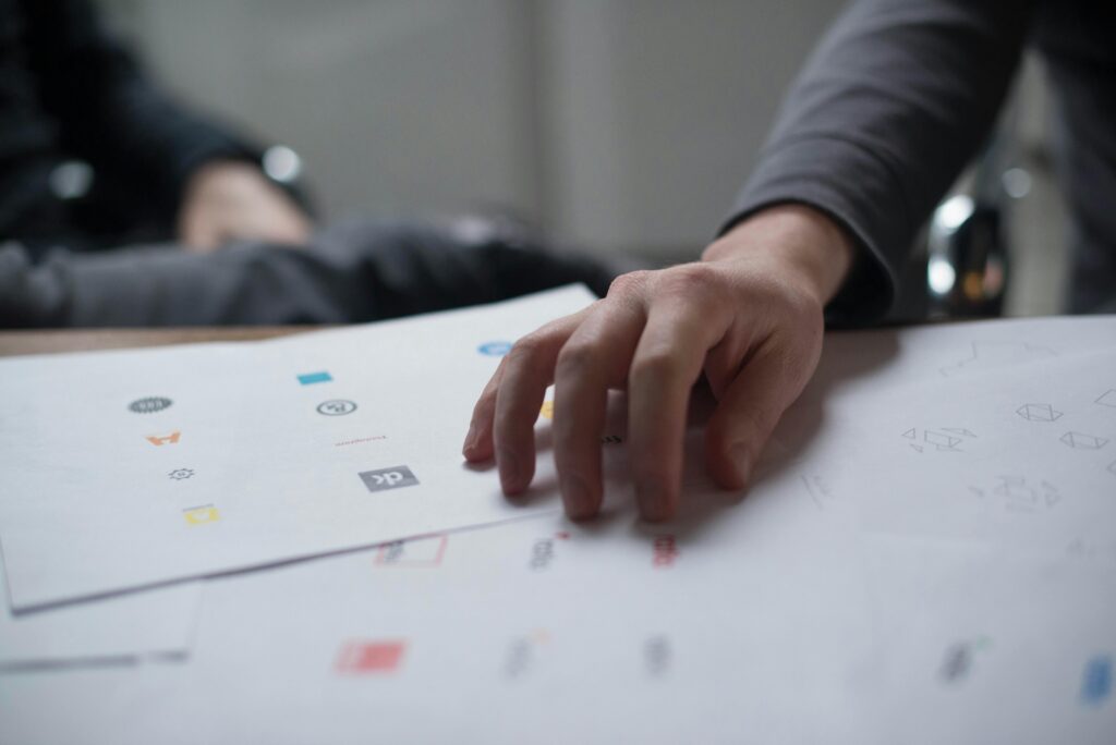 A brand awareness strategist showing a photo to a colleague
