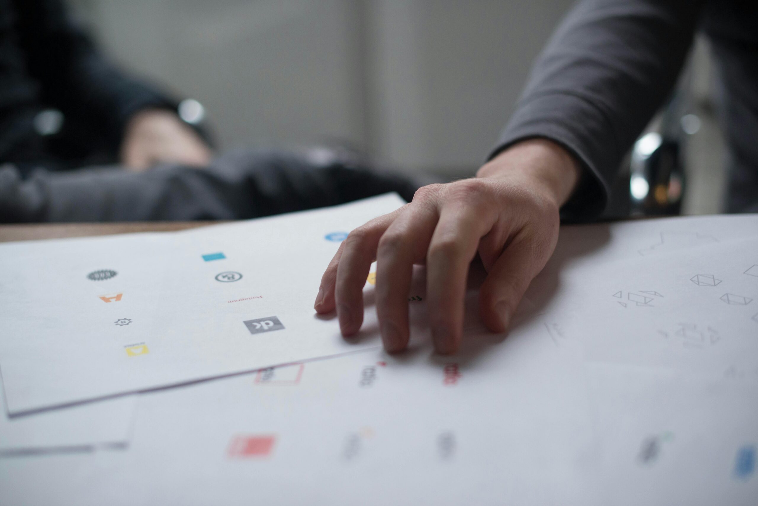 A brand awareness strategist showing a photo to a colleague