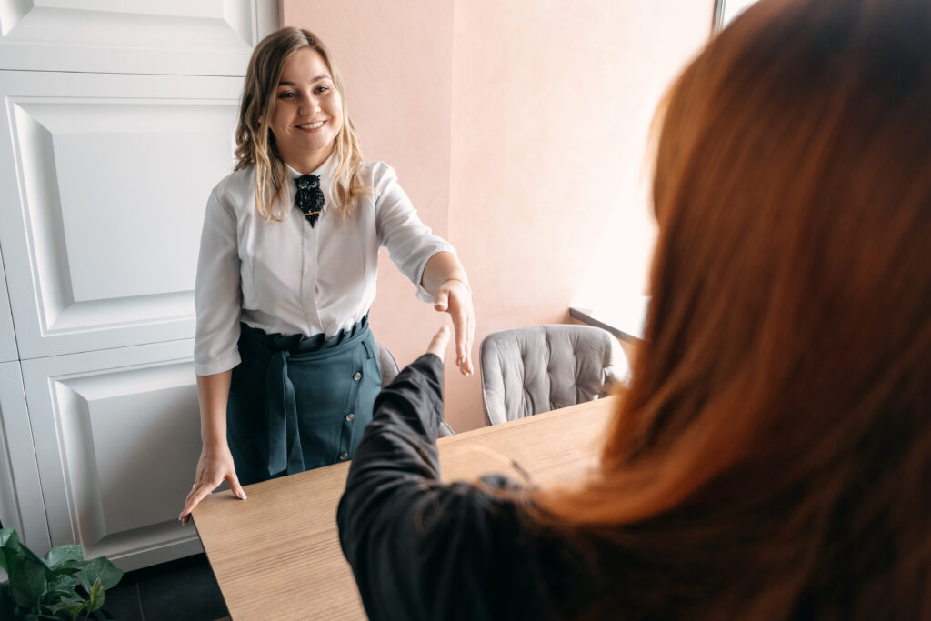 A young professional with plenty of interview preparation, shaking hands with HR